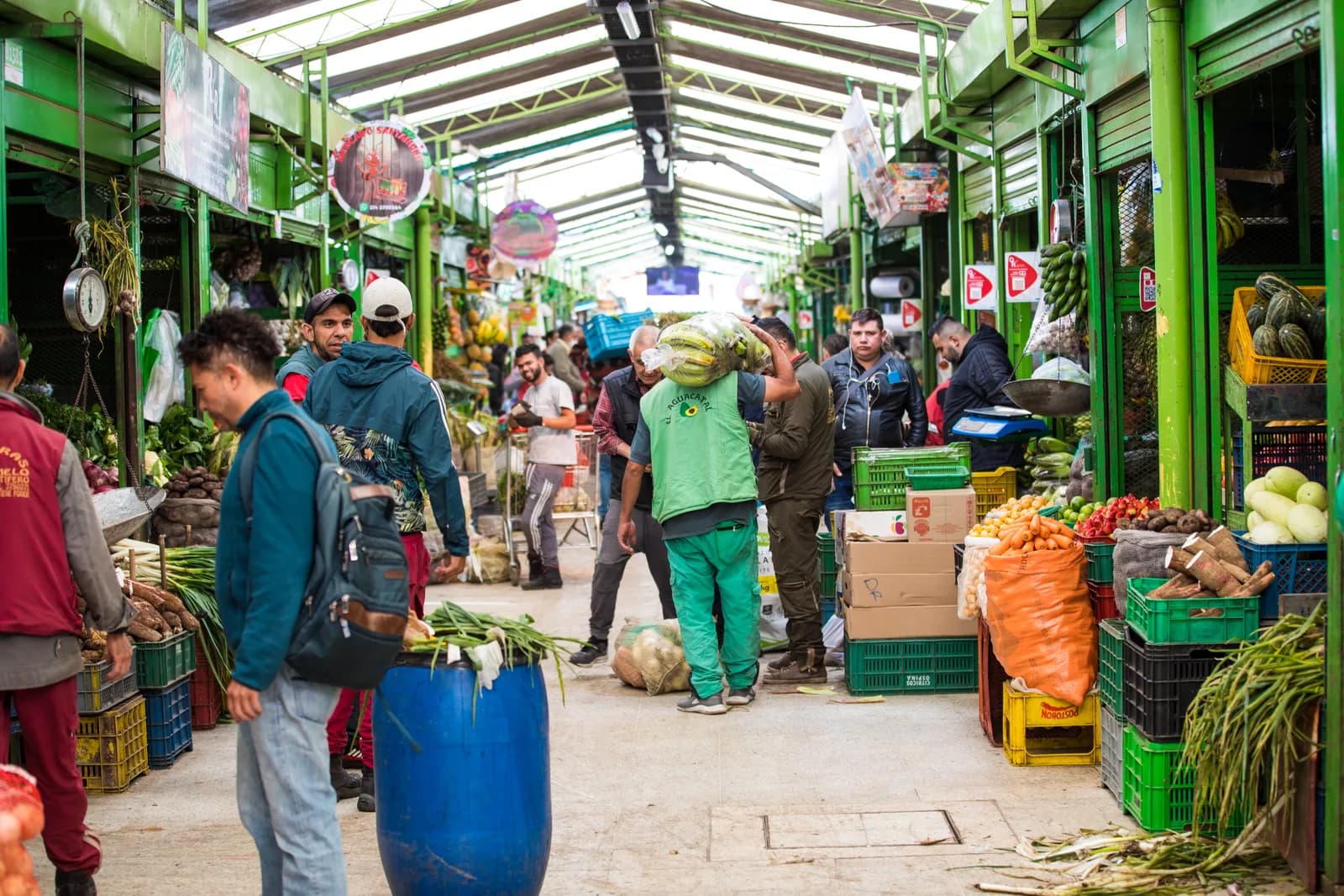 Stalls piled with tropical fruit and produce at a market in Bogotá