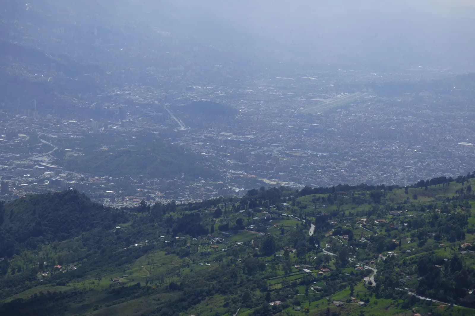 Aerial view over central Medellín with El Poblado's towers in the background