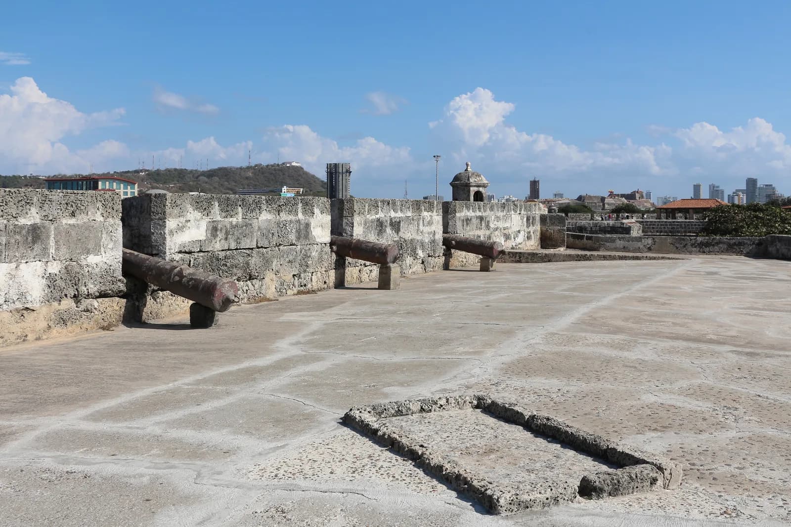 The stone city walls of Cartagena's old walled city under a blue sky