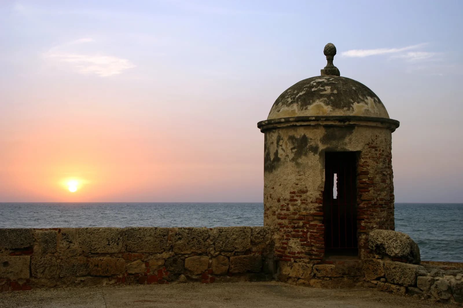 Sunset over the rooftops and cathedral tower of Cartagena's walled Old Town