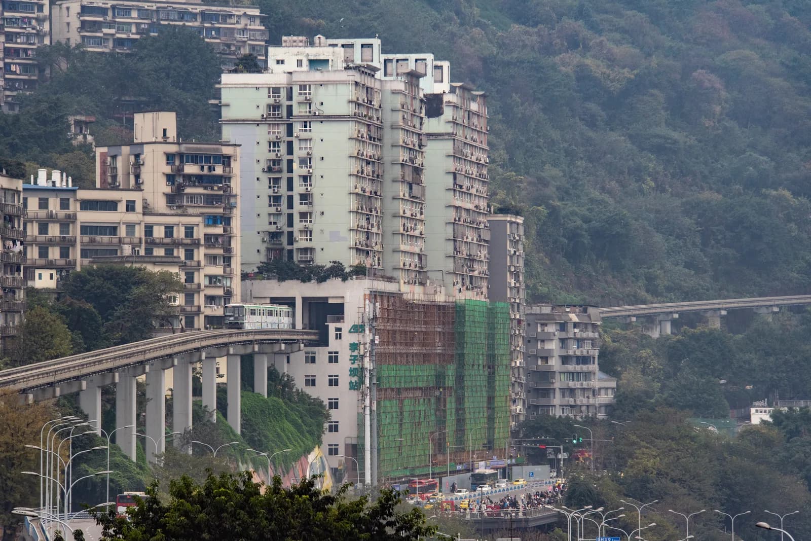 A Chongqing Line 2 monorail train emerging from the residential building at Liziba station