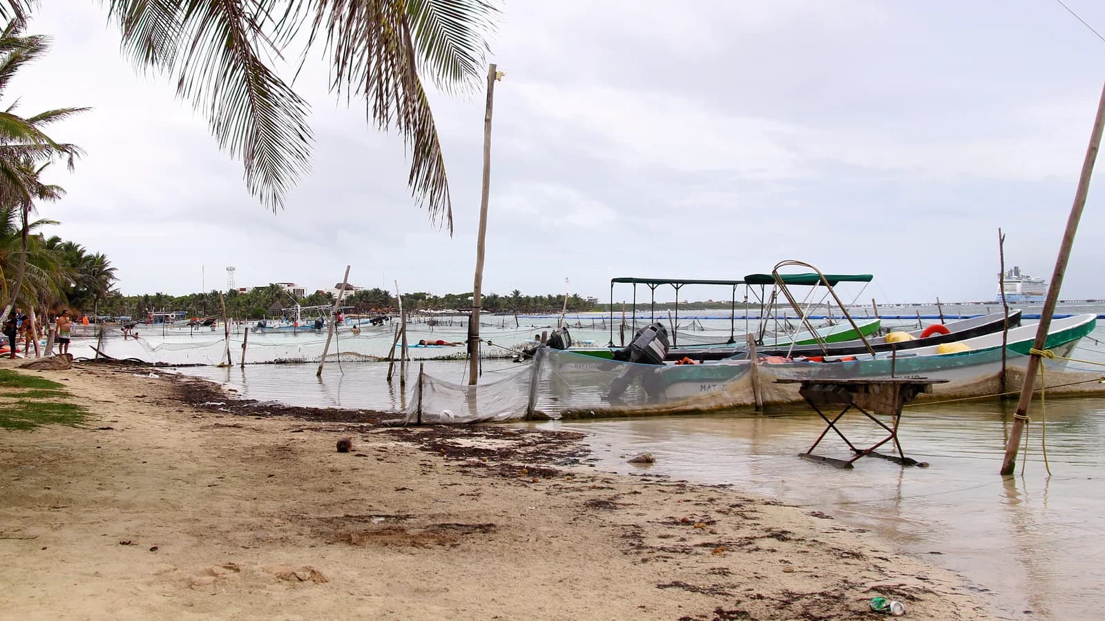 Small boats moored in the calm shallow water off the beach at Mahahual, Quintana Roo