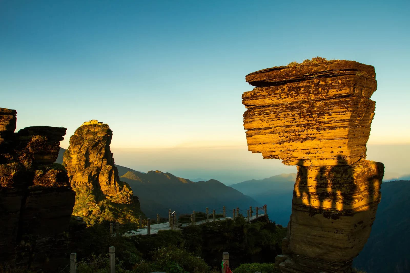Red Clouds Golden Summit at Fanjingshan, a rock spire topped by twin temples rising out of forested mountainside