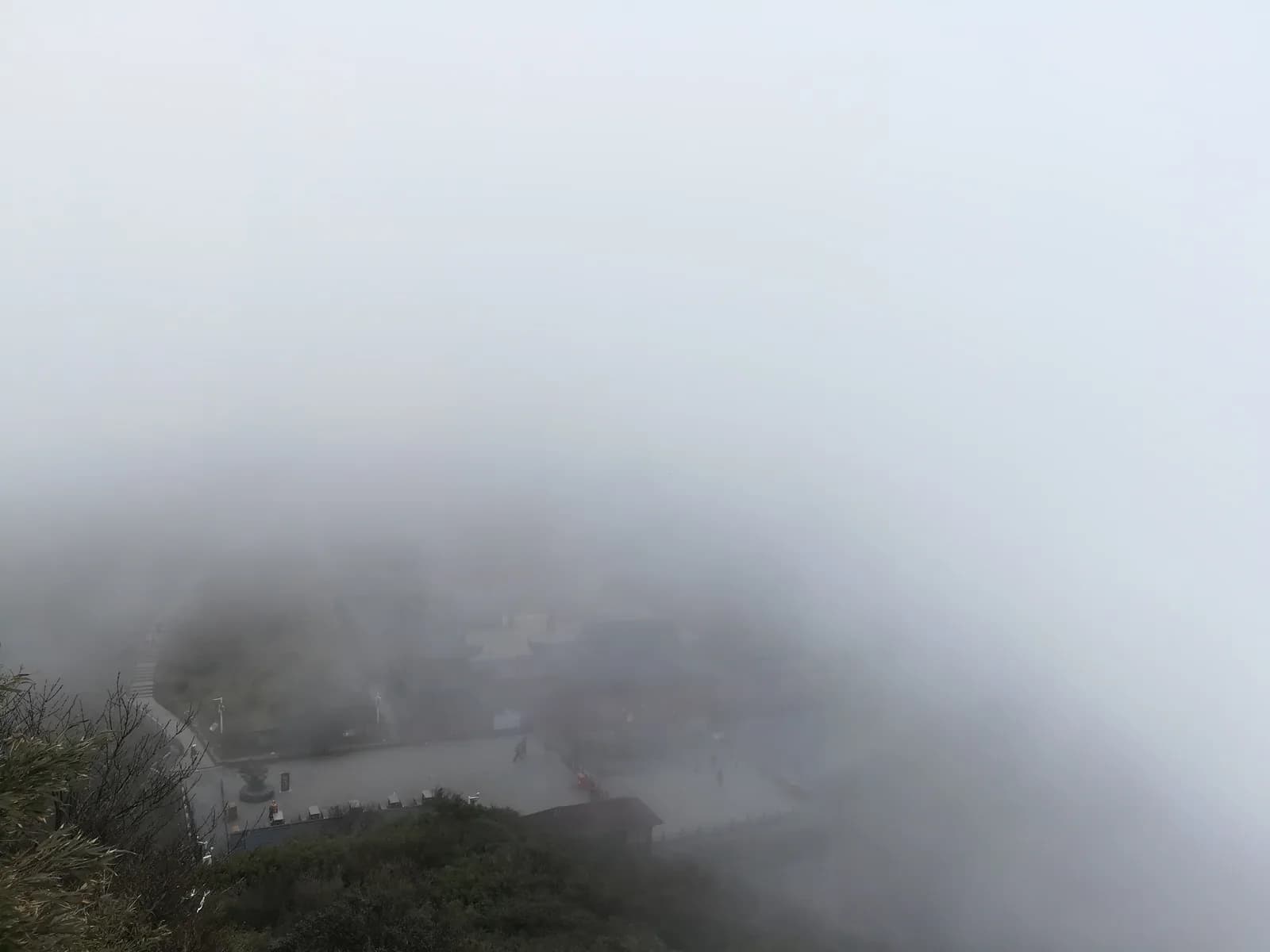 Cheng'en Temple buildings on Mount Fanjing with mist over the surrounding ridgeline