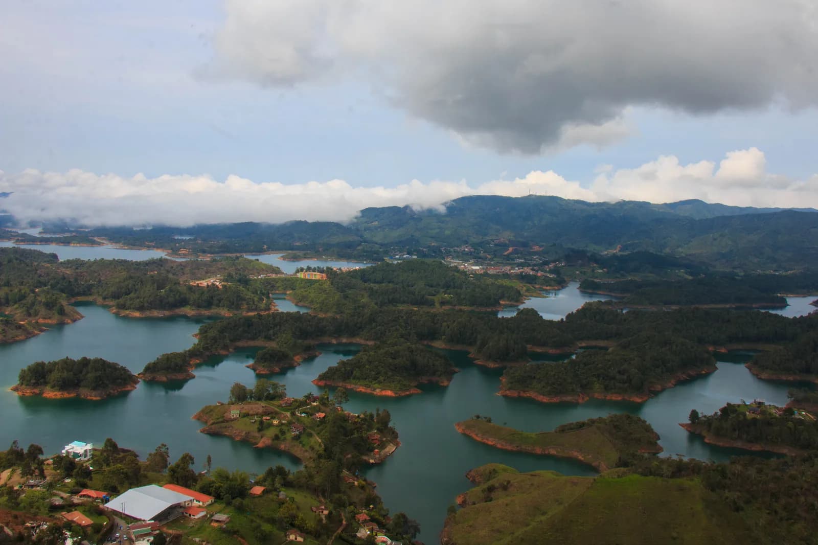 View from the summit of the Piedra del Peñol over the green islands and blue channels of the Guatapé reservoir