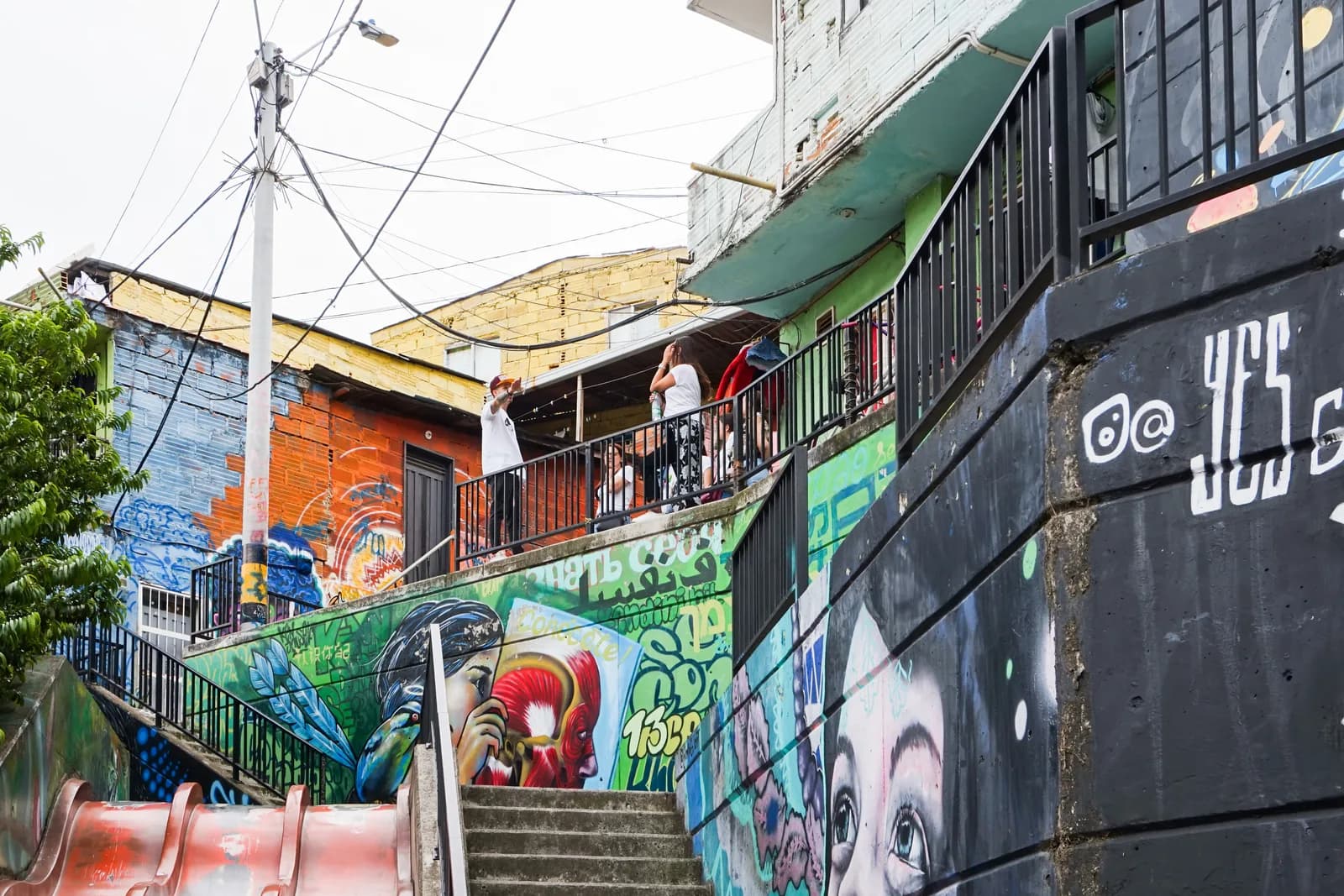 Brightly painted murals covering the stairways and walls of Comuna 13 in Medellín