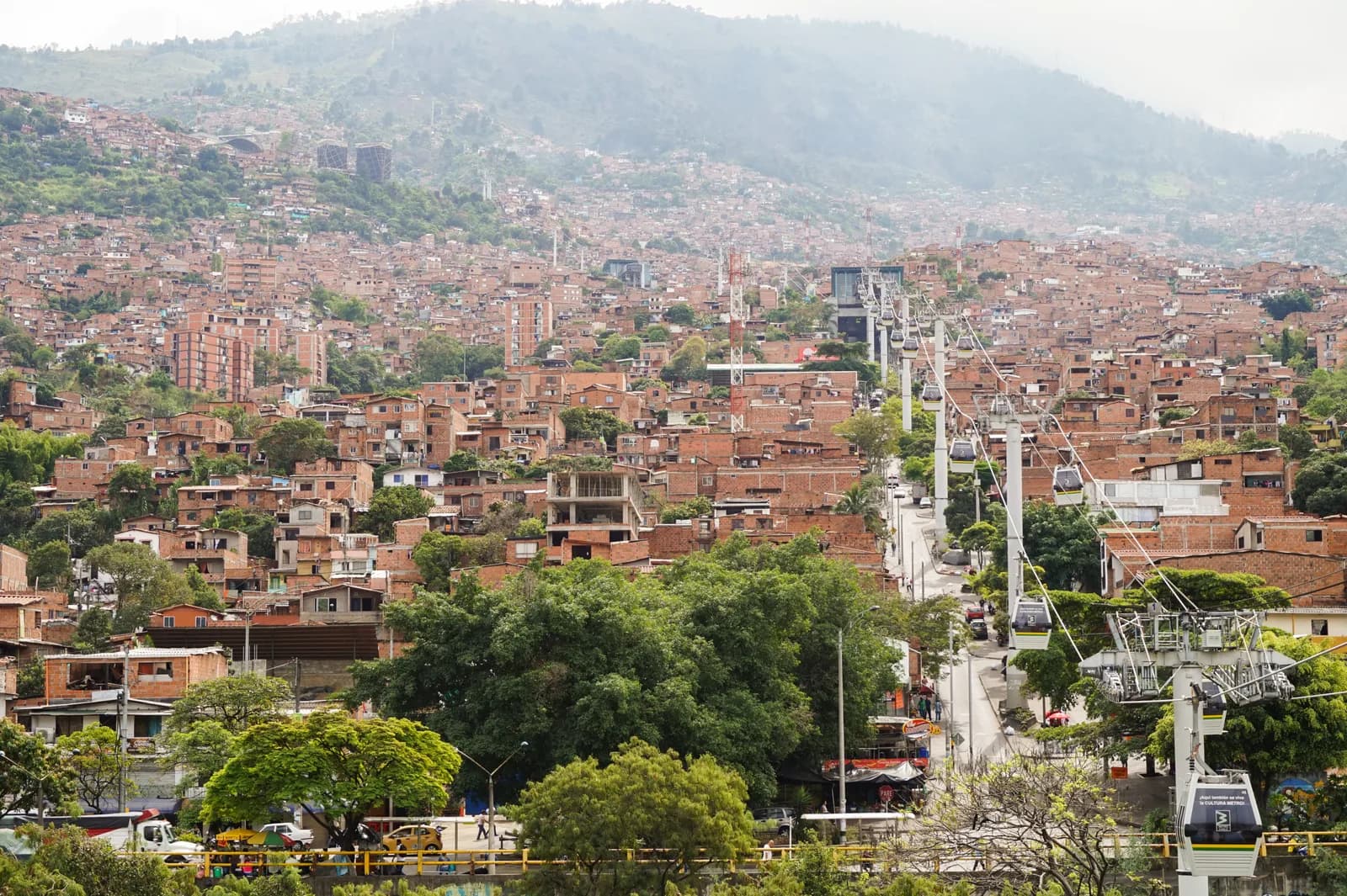 Metrocable gondolas running on cables above the hillside houses of Medellín