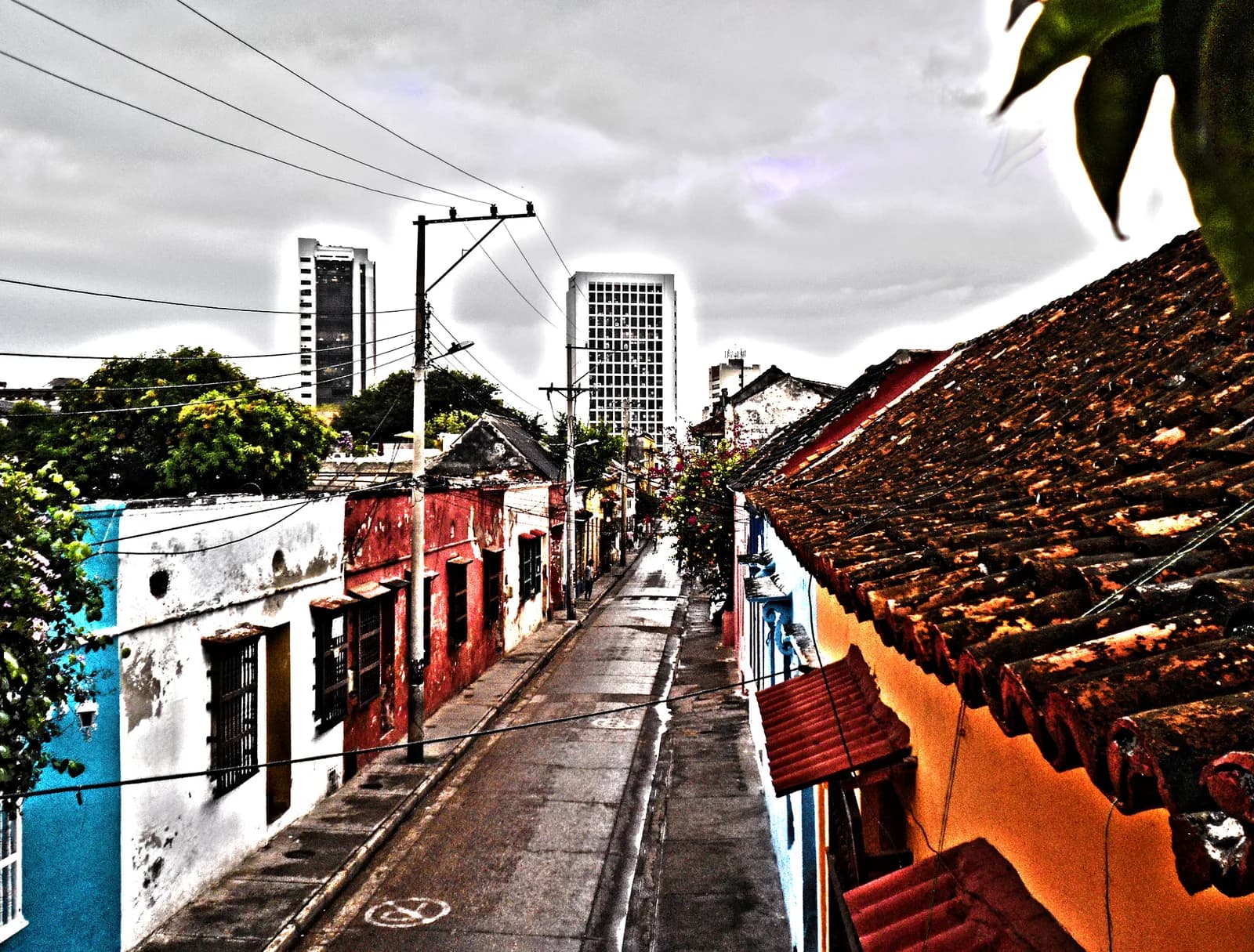 Colorful colonial street draped with flags and street art in the Getsemani neighborhood of Cartagena