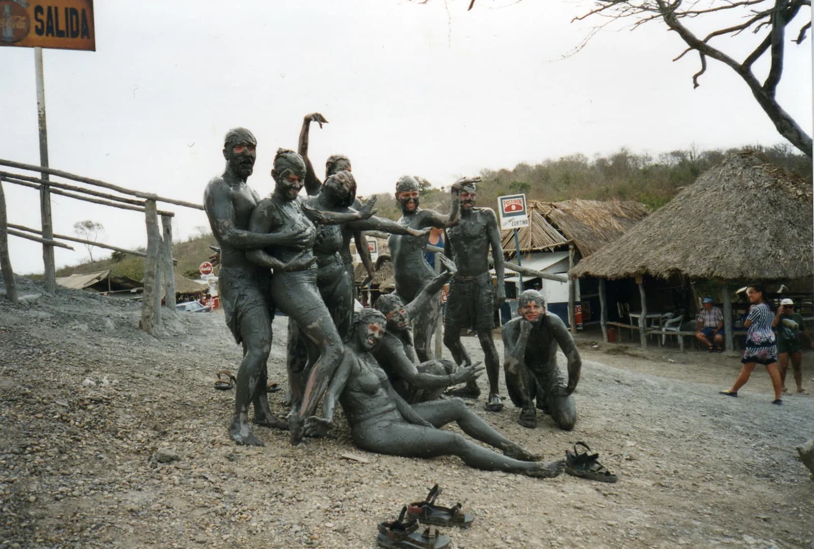 Visitors covered in grey mud inside the crater pool at the top of Volcan del Totumo near Cartagena
