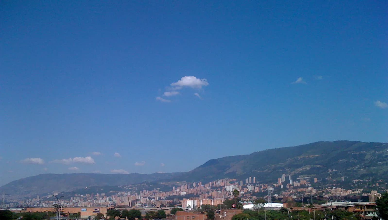 Medellín's high-rises stretching along the Aburrá Valley, seen from the hills near Sabaneta