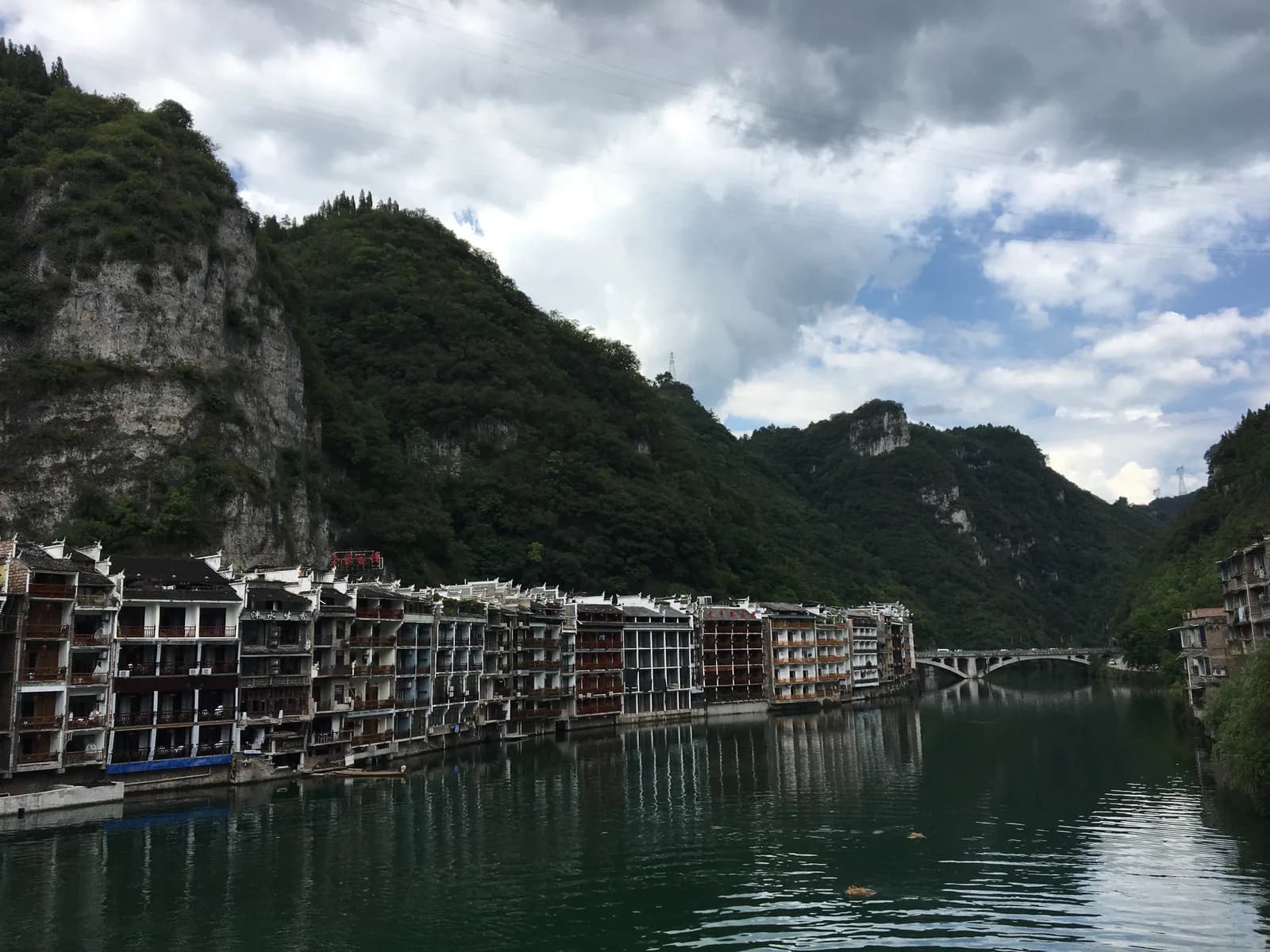 Riverside guesthouses and traditional buildings of Zhenyuan ancient town reflected in the Wuyang River